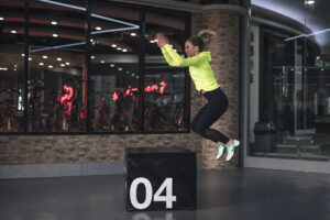 Photo of woman jumping on box